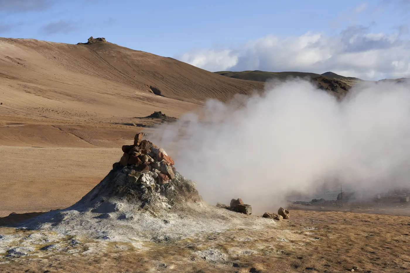 Steam rising over a geothermal slope