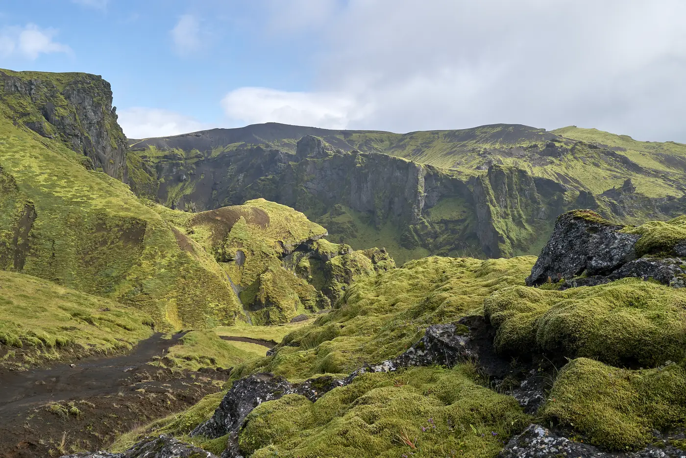 A green highland valley with a road