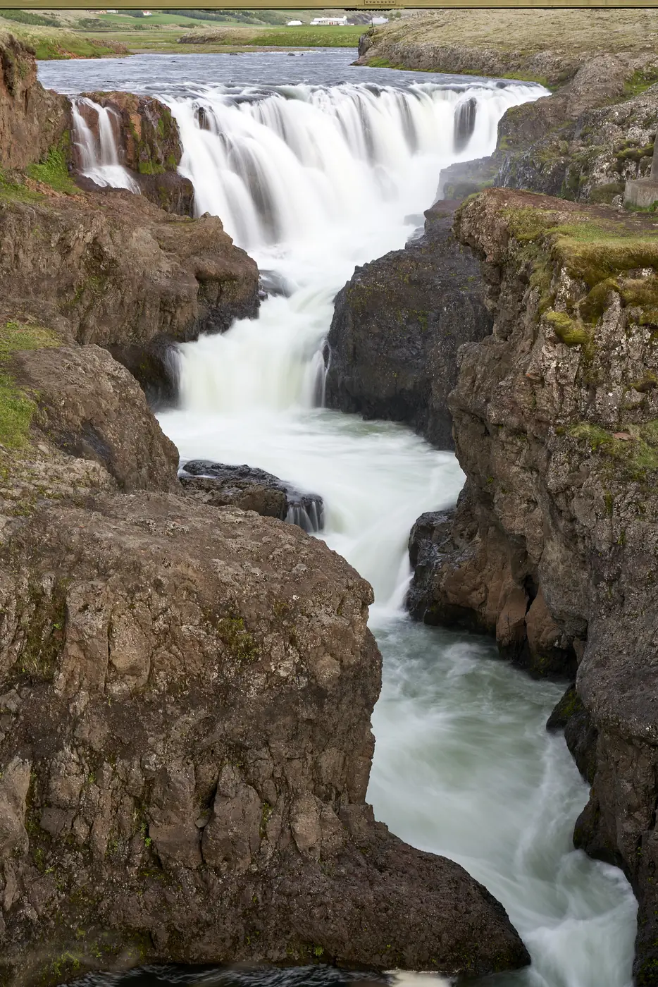 A waterfall on a green slope