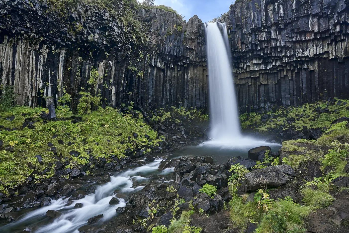 A waterfall in green surroundings